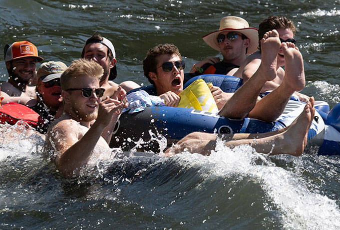 students floating the river