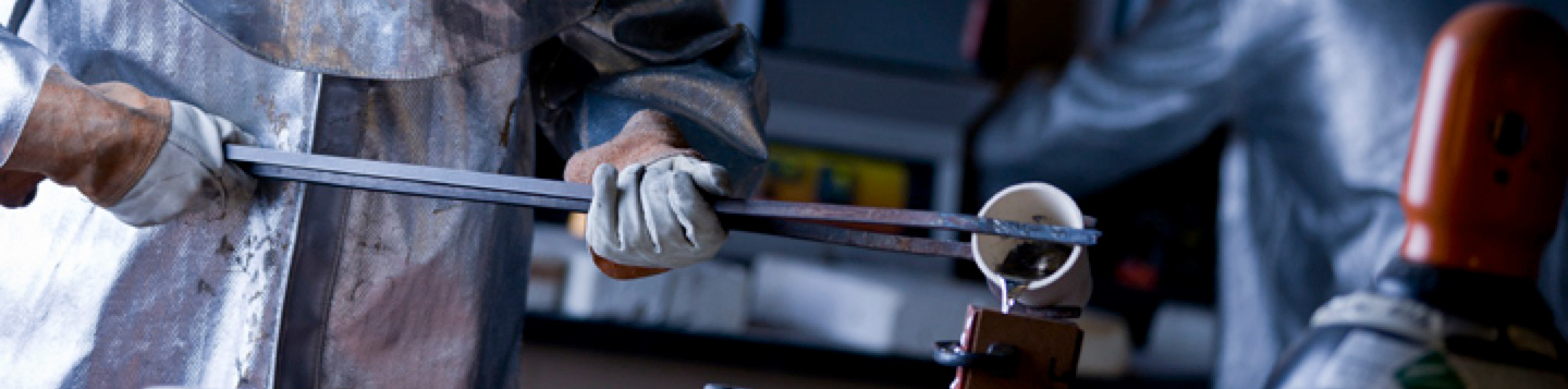 fabrication worker pours metal