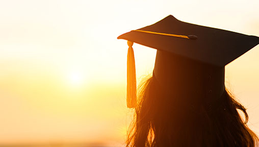 Graduate looking at the sunset
